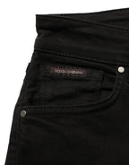 Black cotton stretch skinny denim jeans by Dolce & Gabbana shown on a model, highlighting slim fit and stylish design.