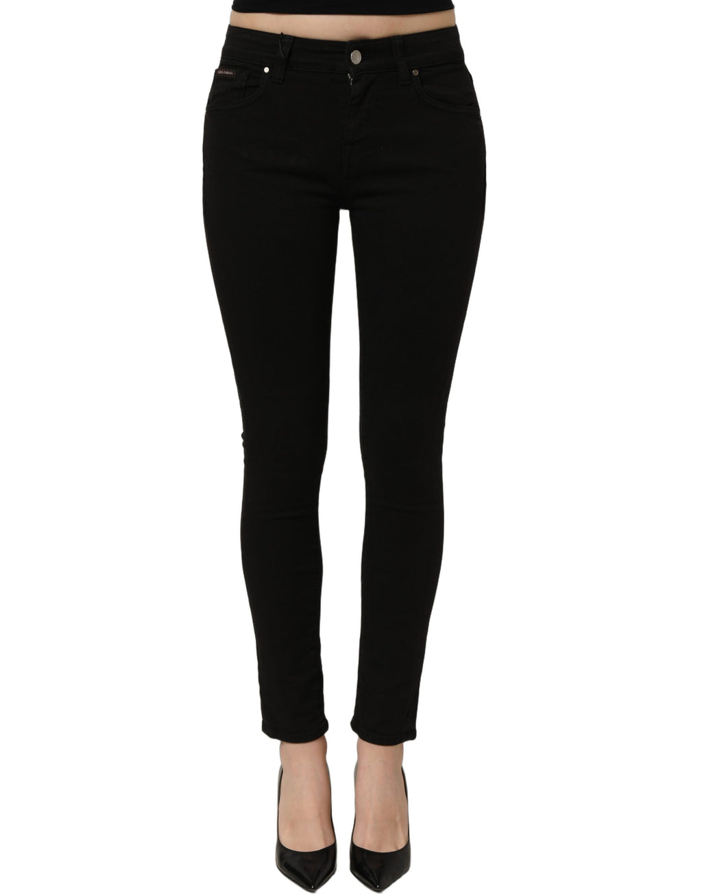 Black cotton stretch skinny denim jeans by Dolce & Gabbana, close-up of fitted design and classic five-pocket style.