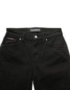 Black cotton stretch skinny denim jeans by Dolce & Gabbana, shown hanging with a fitted, sleek design and classic five-pocket style.