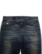 Dolce & Gabbana blue cotton stretch skinny denim jeans displayed on a hanger with visible stitching and classic five-pocket design.