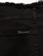 Black cotton skinny denim trousers by Dolce & Gabbana, shown on a model with a fitted style and classic jean details.