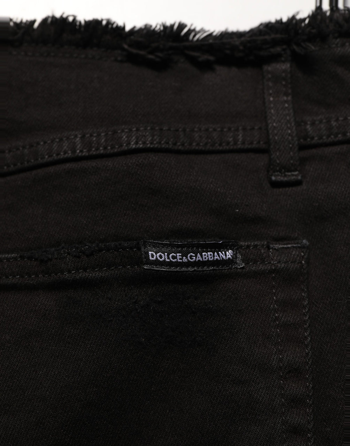 Black cotton skinny denim trousers by Dolce & Gabbana, shown on a model with a fitted style and classic jean details.