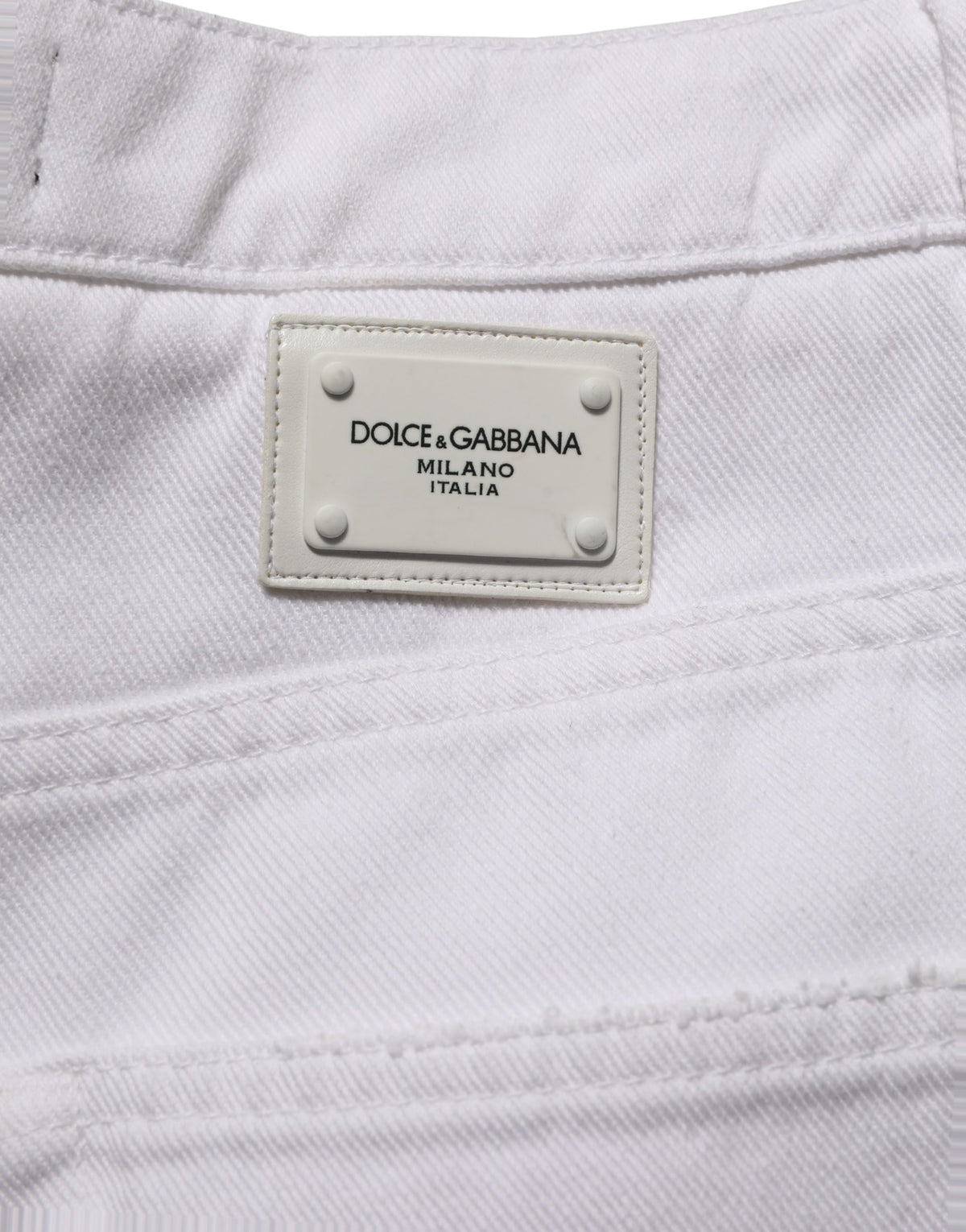 Dolce & Gabbana white cotton stretch wide-leg denim jeans laid flat, showing the high-waist and relaxed fit design.