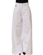 Dolce & Gabbana white cotton stretch wide-leg denim jeans displayed on a hanger with front and back view.