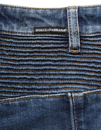 Dark blue cotton stretch skinny denim jeans by Dolce & Gabbana displayed on a hanger with visible stitching and classic five-pocket design.