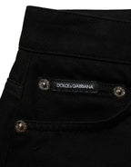 Dark gray cotton Dolce & Gabbana mid-rise denim hot pants shorts with distressed details and classic five-pocket design.