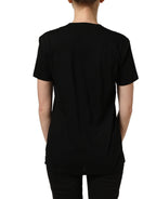 Black cotton Dolce & Gabbana crew neck short sleeve T-shirt displayed on a hanger with visible D&G logo.