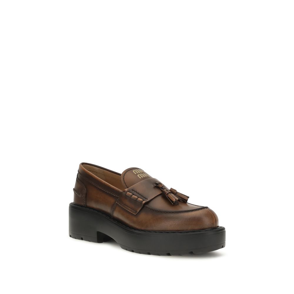 Brown calf leather Miu Miu Bos Taurus platform loafers with chunky sole and sleek design, perfect for stylish casual wear.