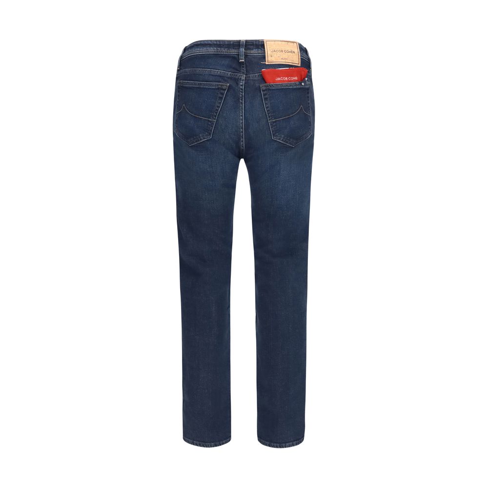 Jacob Cohen blue cotton slim fit jeans displayed on a hanger, showcasing the modern design and classic denim style.