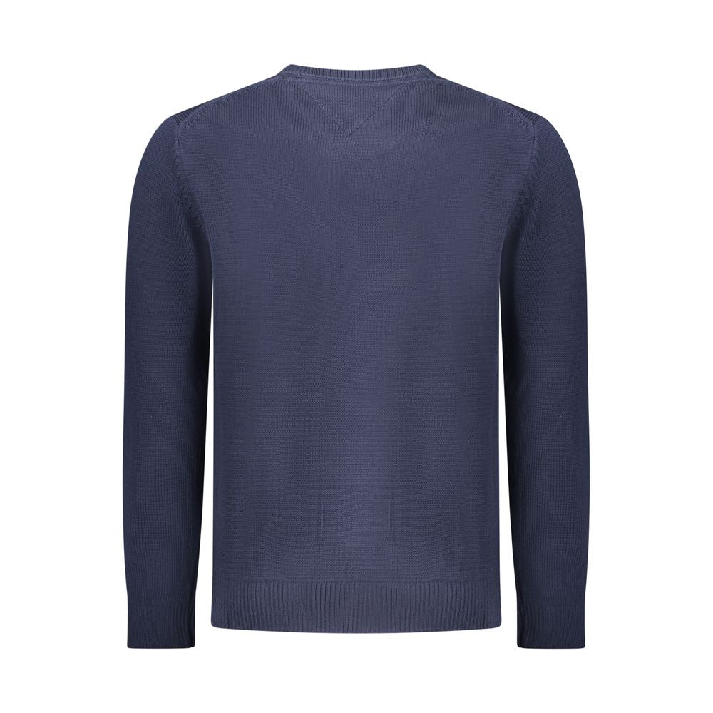 Tommy Hilfiger blue cotton men's sweater with ribbed cuffs and crew neckline, styled casually on a model.