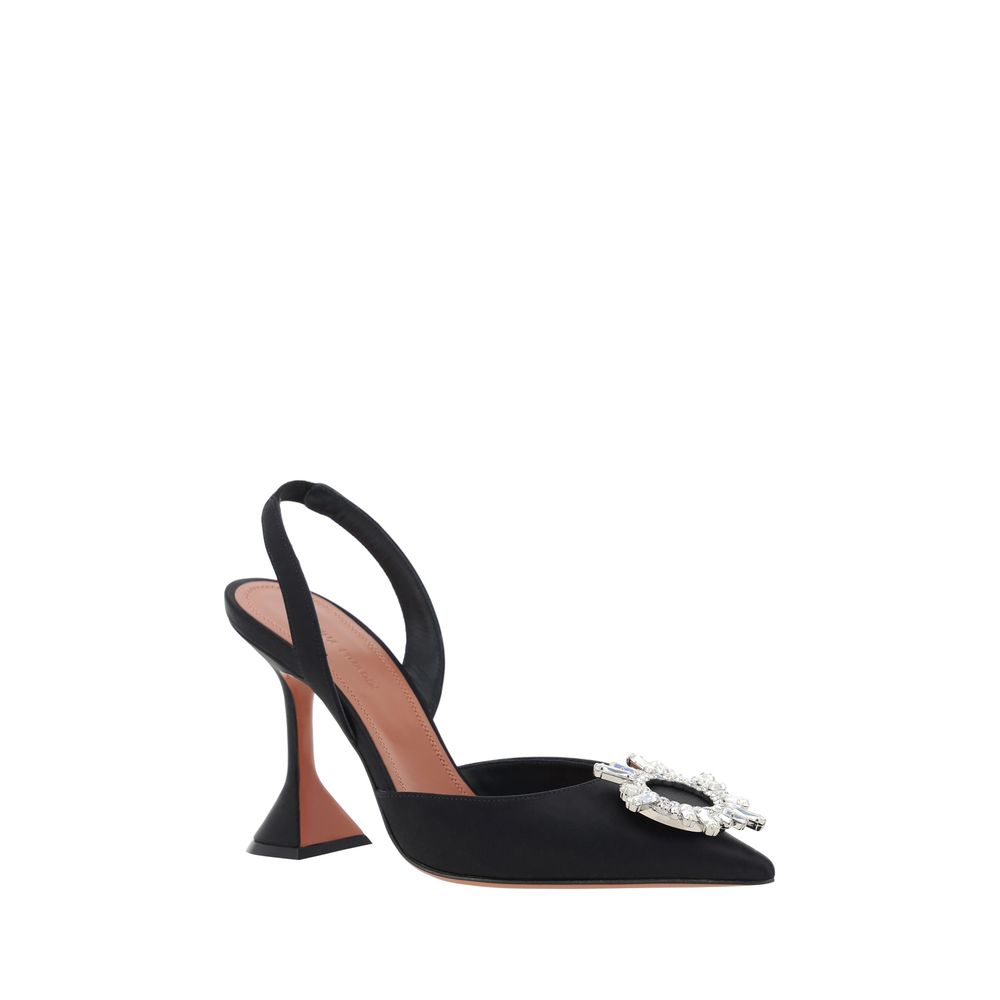 Black satin high heel pumps by Amina Muaddi with pointed toes and sleek design, perfect for elegant evening wear.