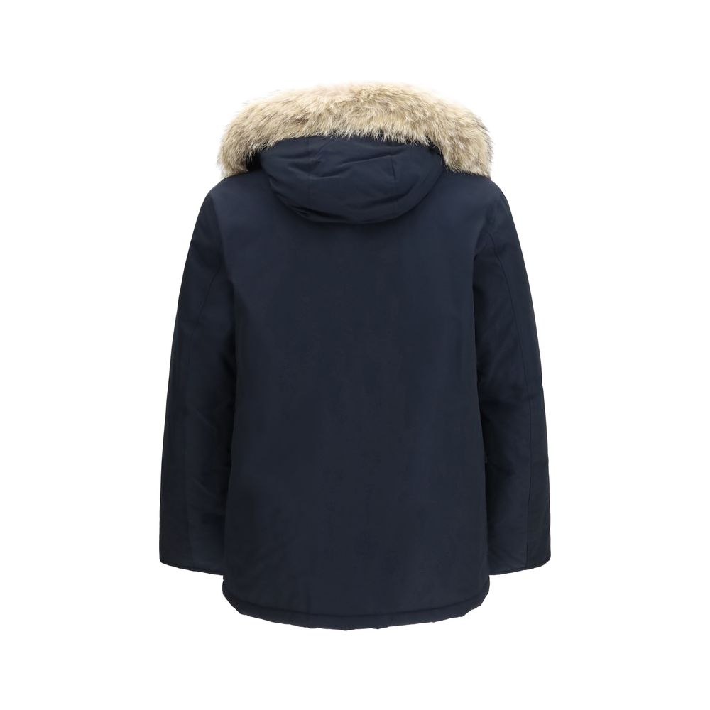Woolrich blue cotton parka with a hood and front pockets, stylish and warm outerwear for cold weather.