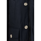 Woolrich blue cotton parka with hood, front zipper, and side pockets, designed for warmth and casual outdoor wear.