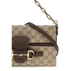 Gucci beige fabric shoulder bag with adjustable strap and gold-tone hardware, stylish accessory for everyday use.