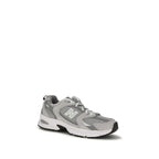 Gray New Balance athletic sneakers made of polyamide, featuring a sleek design and supportive athletic footwear for active wear.