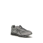 Gray New Balance athletic sneakers made of fabric, featuring a sleek design and cushioned soles for comfortable sportswear.