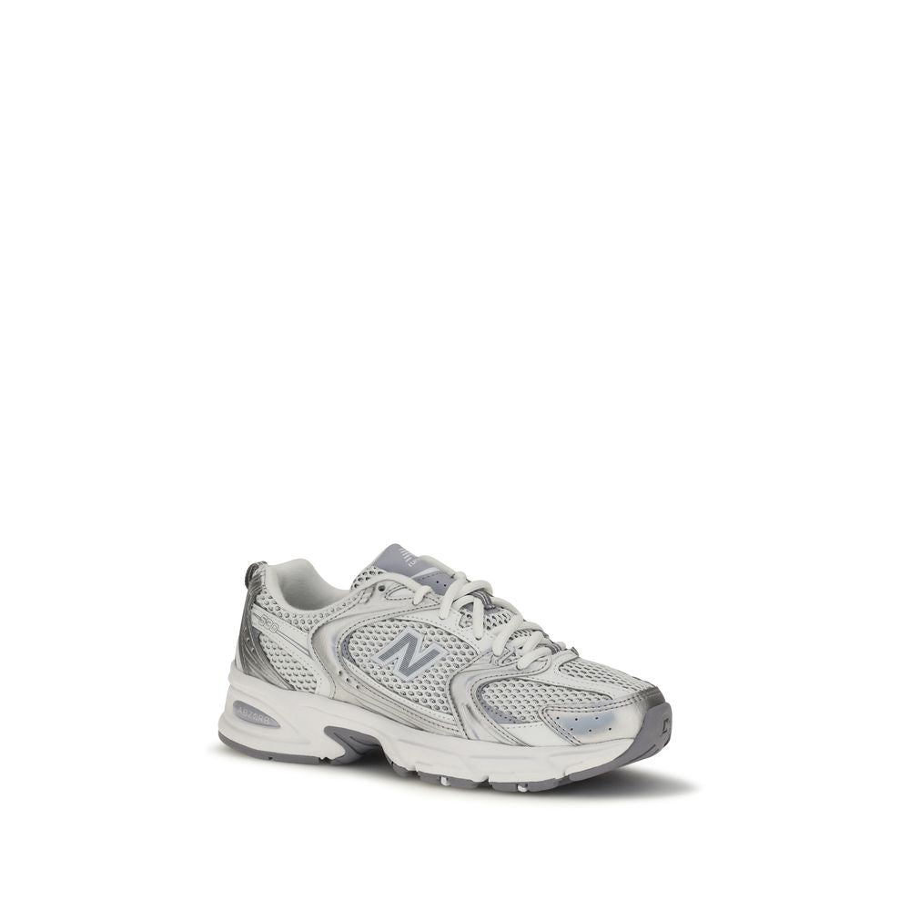 White New Balance athletic sneakers with polyamide upper, featuring a sleek design and cushioned sole for active wear.