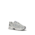 White New Balance athletic sneakers with polyamide upper, featuring a sleek design and cushioned sole for active wear.