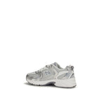 White New Balance athletic sneakers with polyamide uppers, featuring a sporty design and cushioned soles for active wear.