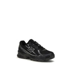 Black New Balance athletic sneakers with polyamide uppers, featuring a sleek design and cushioned soles for sports and casual wear.