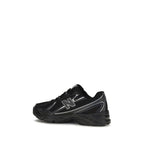 Black New Balance athletic sneakers made of polyamide with sporty design and modern lacing, suitable for running and casual wear.