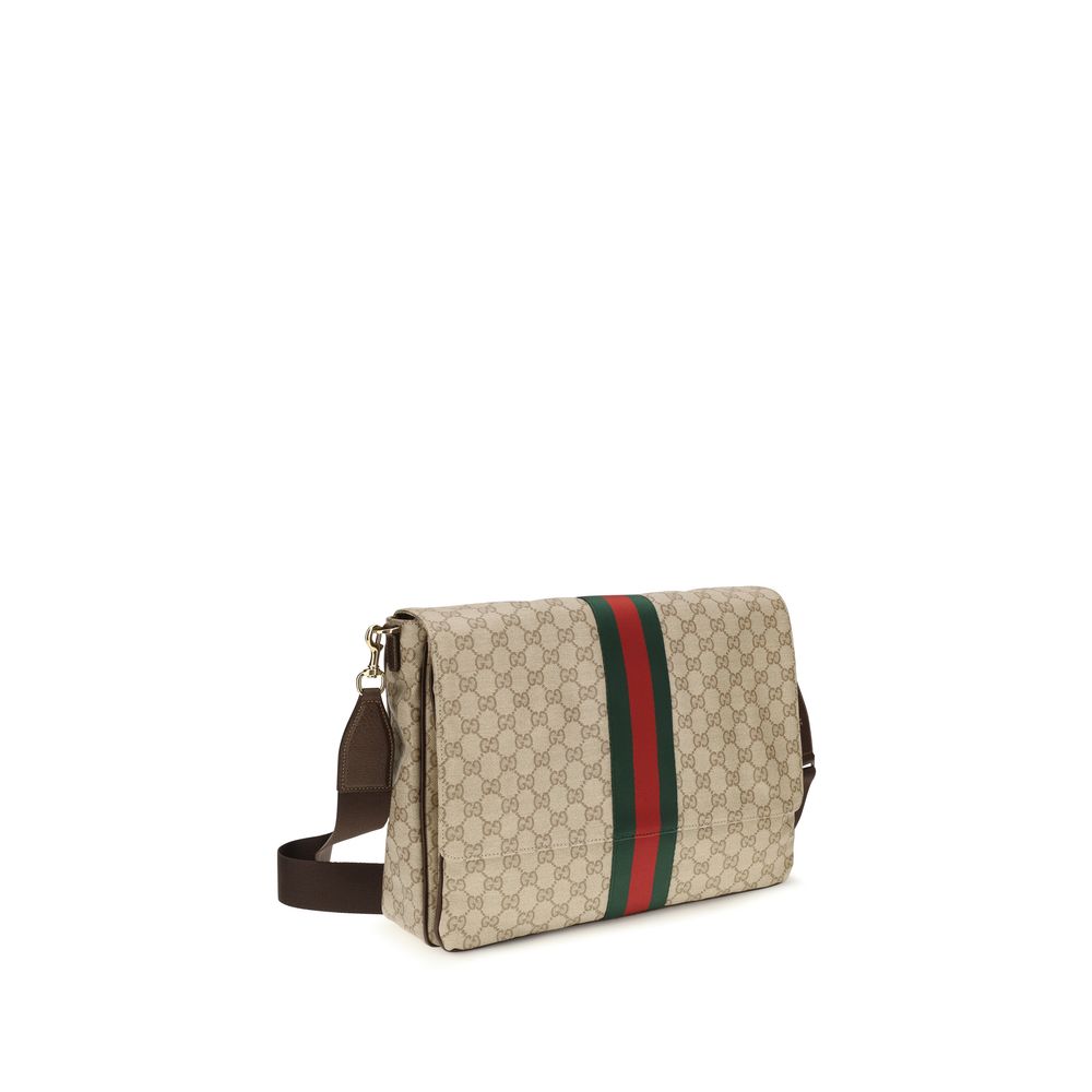 Gucci beige cotton shoulder bag with adjustable strap and subtle branding, displayed on a neutral background.