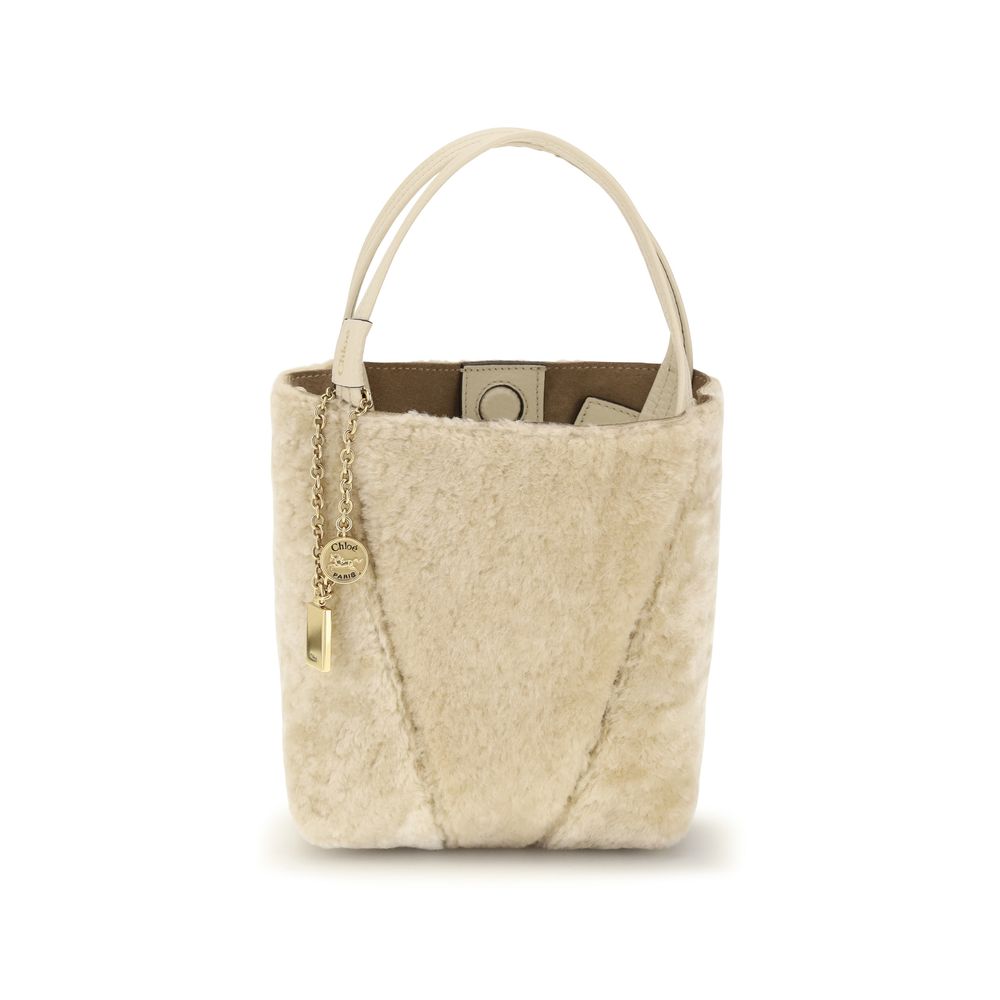Chloé beige calf leather Bos Taurus handbag with structured design and top handle, showcasing elegant craftsmanship and gold-tone hardware.