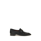 Chloé black calf leather Bos Taurus slip-on loafers with sleek design and rounded toes, displayed on a plain background.