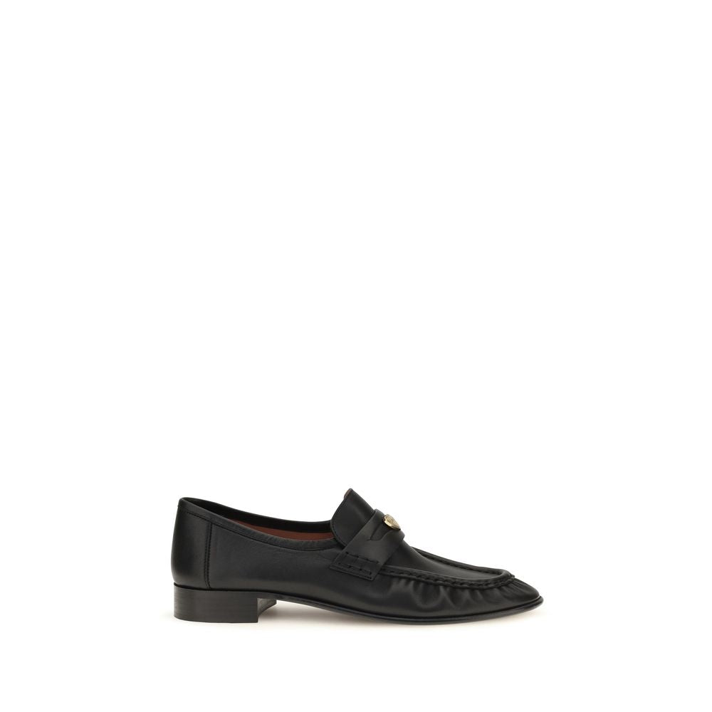Chloé black calf leather Bos Taurus slip-on loafers with sleek design and rounded toes, displayed on a plain background.