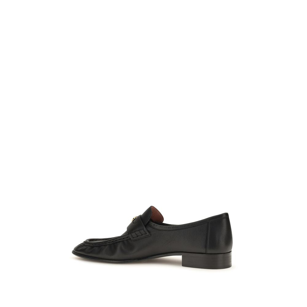 Chloé black calf leather Bos Taurus slip-on loafers with sleek design and rounded toes, stylish and comfortable for everyday wear.