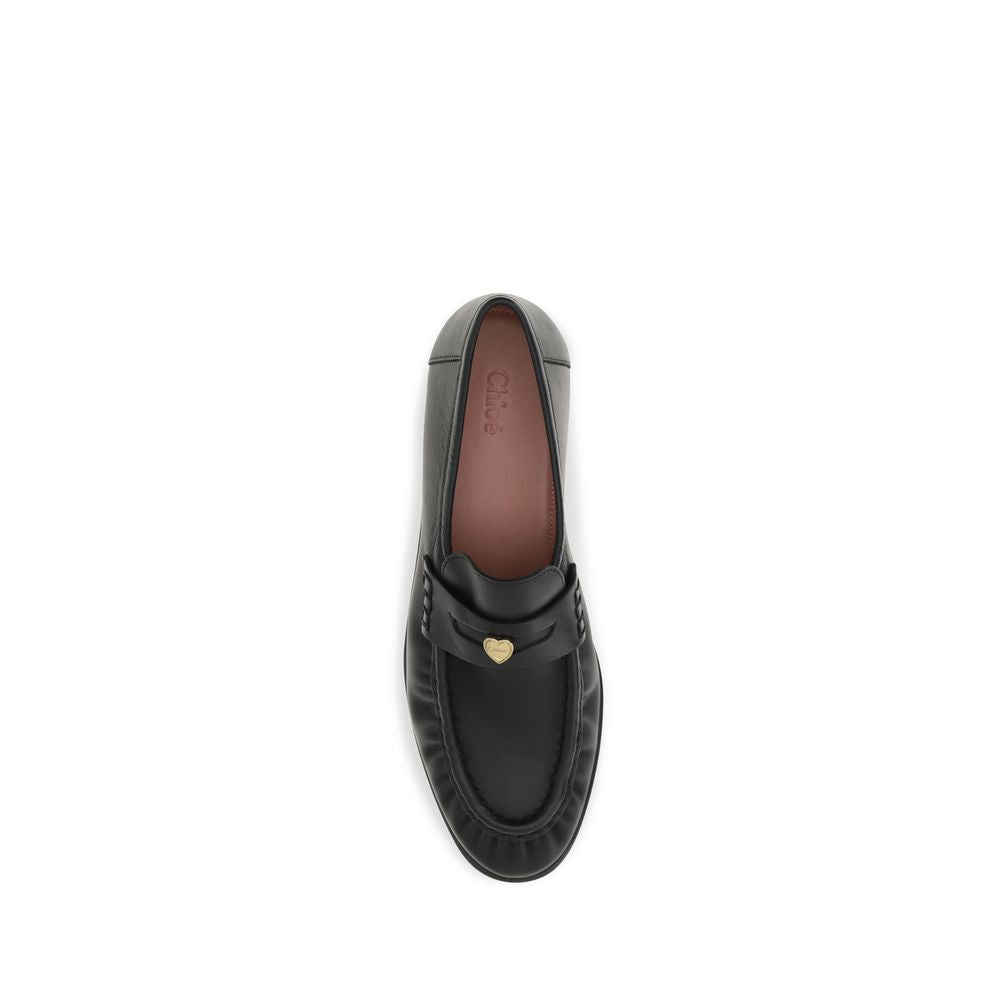 Chloé black calf leather Bos Taurus slip-on loafers with sleek design and minimalist style.