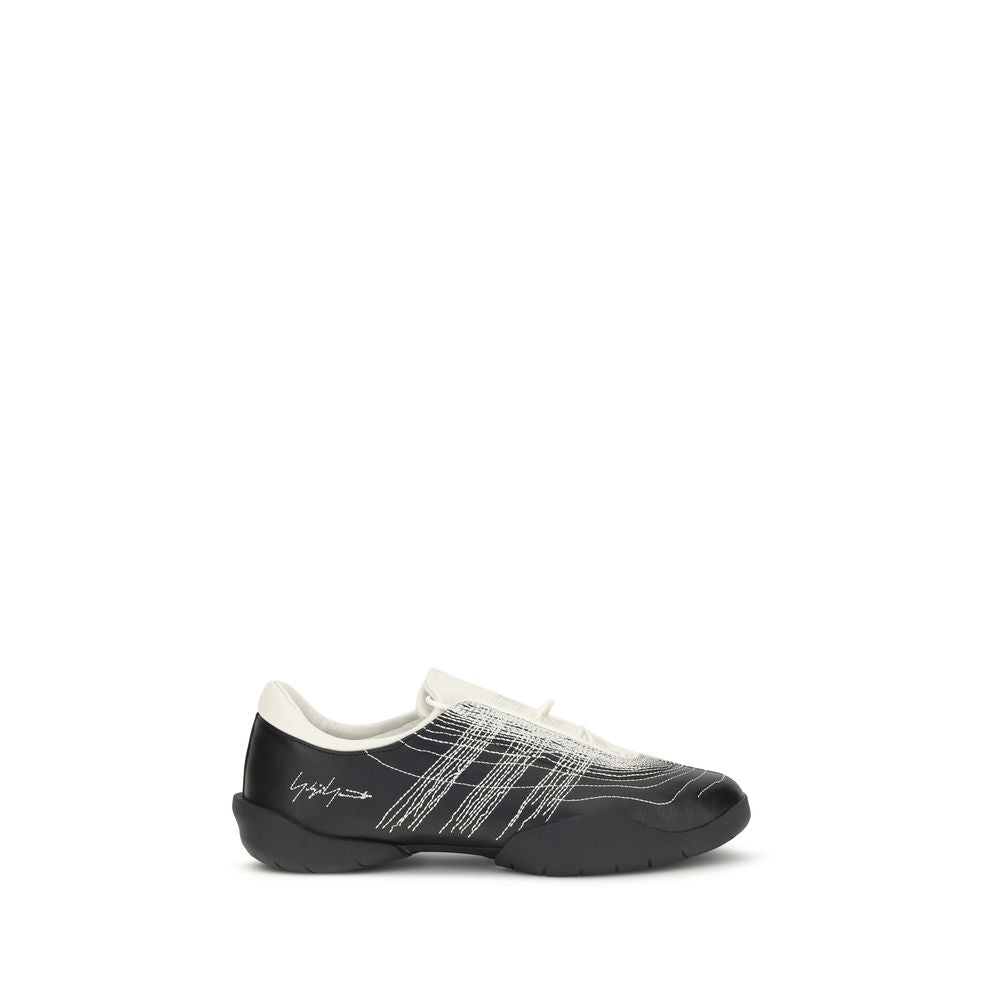 Y-3 black rubber athletic sneakers with sleek design and textured soles, perfect for sporty and casual wear.
