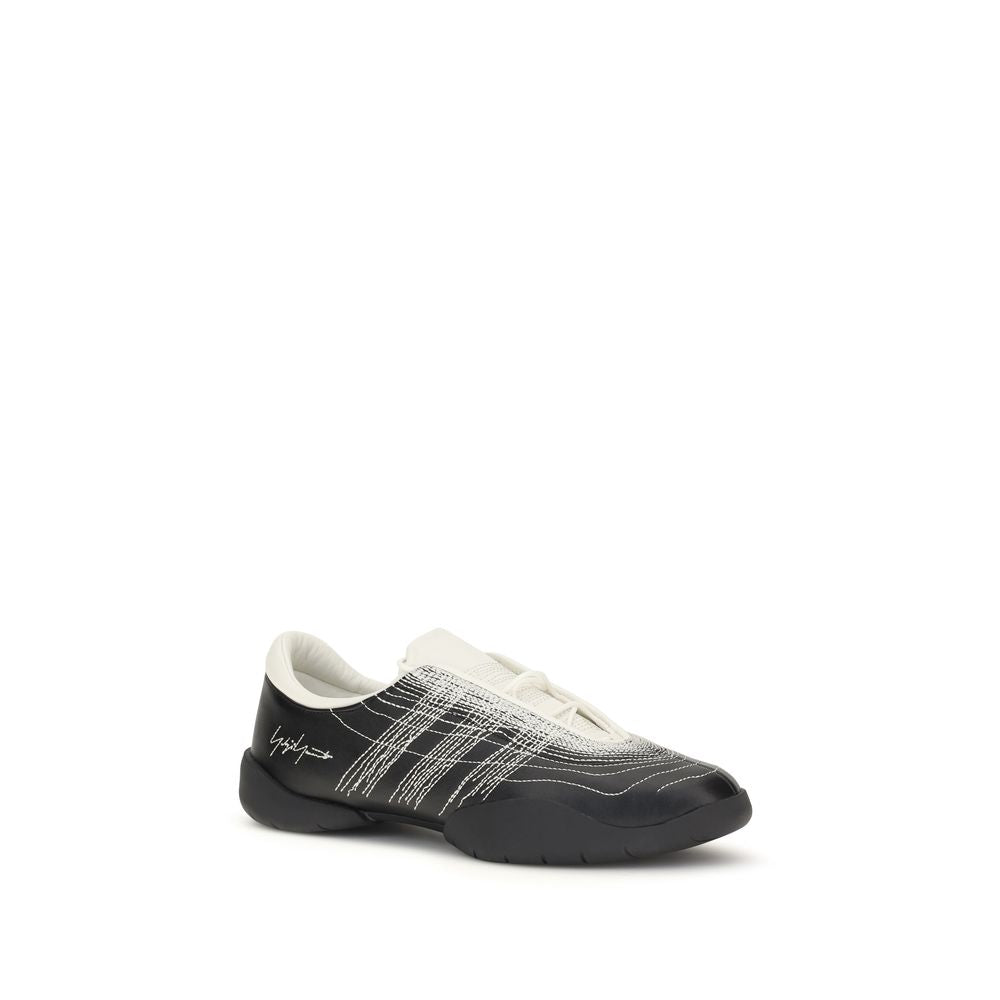 Y-3 black rubber athletic sneakers with sleek design and textured soles, perfect for sports and casual wear.