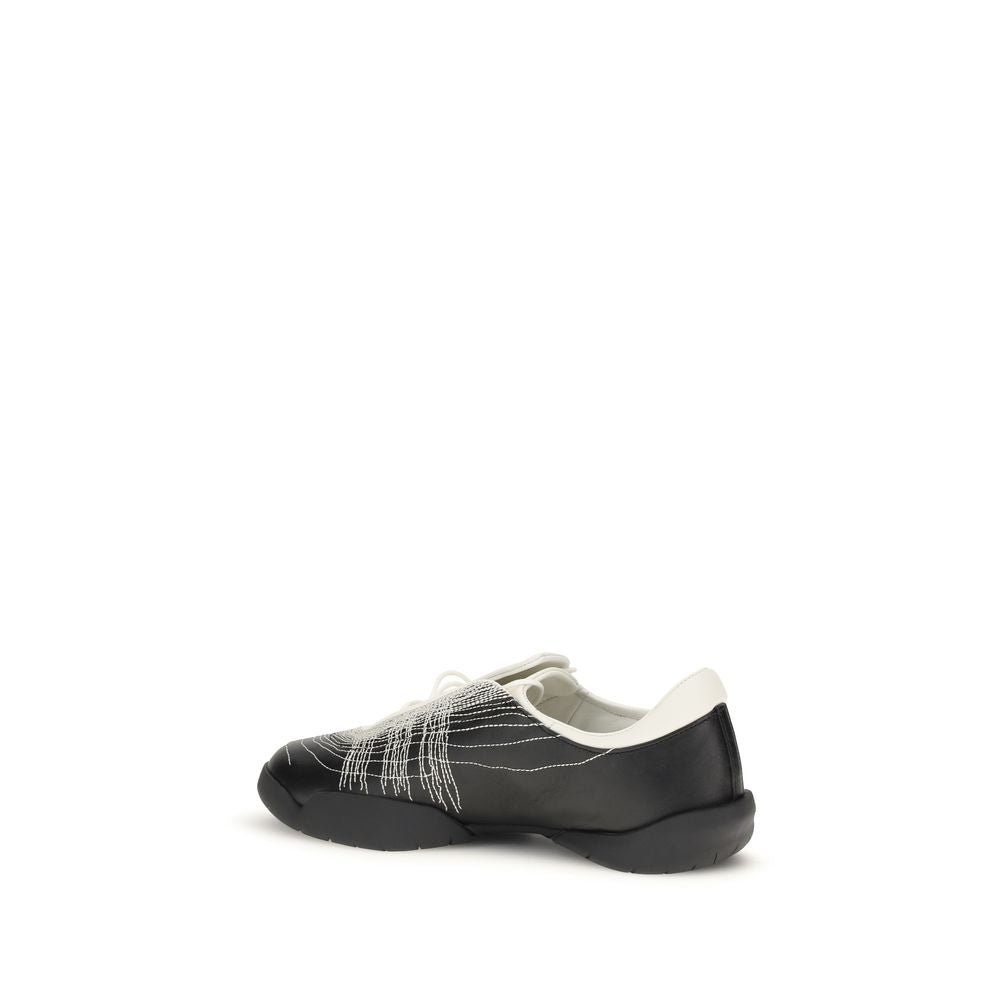 Y-3 black rubber athletic sneakers with sleek design and textured soles, ideal for sporty and casual wear.