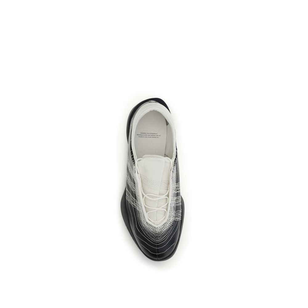 Y-3 black rubber athletic sneakers with sleek design and textured soles, suitable for sports and casual wear.