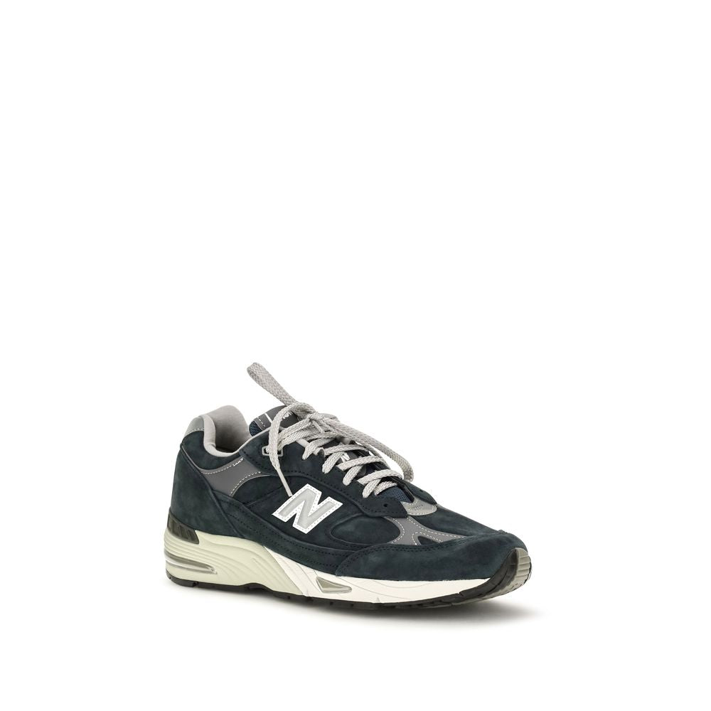 Blue suede leather New Balance athletic sneakers with white soles and laces, designed for sporty comfort and style.