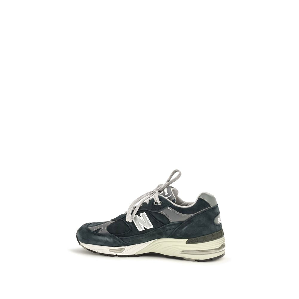 Blue suede leather athletic sneakers by New Balance, featuring sporty design and white rubber soles.