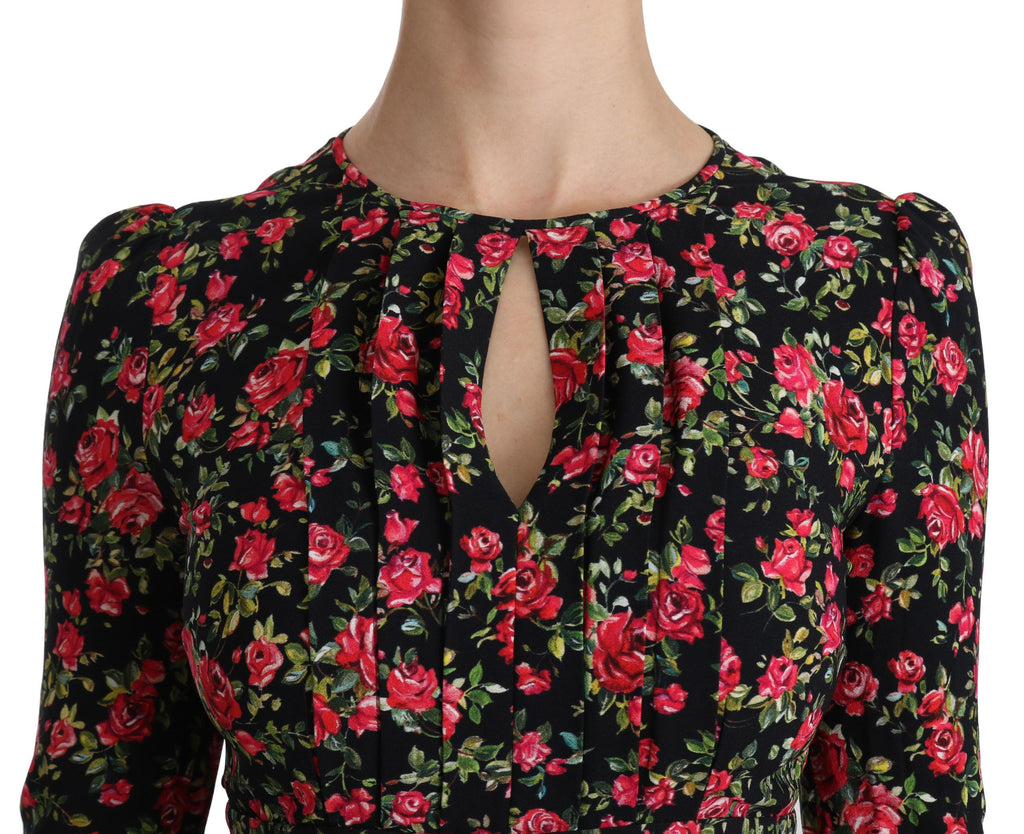 Black floral Dolce & Gabbana long-sleeve knee-length dress displayed on a hanger with detailed floral pattern.