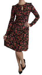 Black floral long-sleeve knee-length dress by Dolce & Gabbana with elegant design and fitted silhouette.