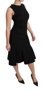 Dolce & Gabbana black fit and flare wool stretch sheath dress displayed on a model, showcasing elegant design and tailored fit.