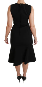 Dolce & Gabbana black fit flare wool stretch sheath dress displayed on a hanger, showcasing its elegant design and tailored fit.