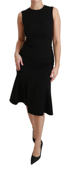 Dolce & Gabbana black fit flare wool stretch sheath dress displayed on a hanger, showcasing its elegant design and tailored fit.