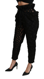 Black floral lace tapered high-waist pants by Dolce & Gabbana, featuring intricate lace detailing and a fitted high-rise silhouette.