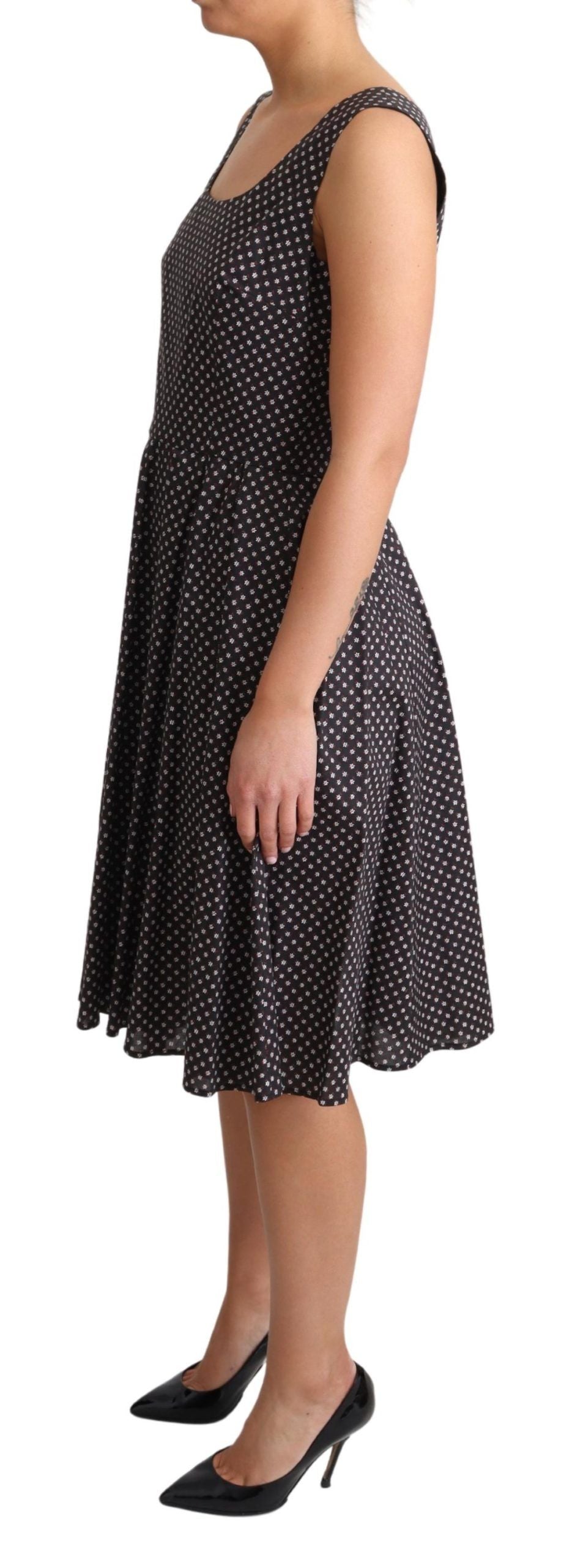 Black floral cotton Dolce & Gabbana A-line stretch dress with a fitted bodice and flared skirt, showcasing elegant floral pattern.