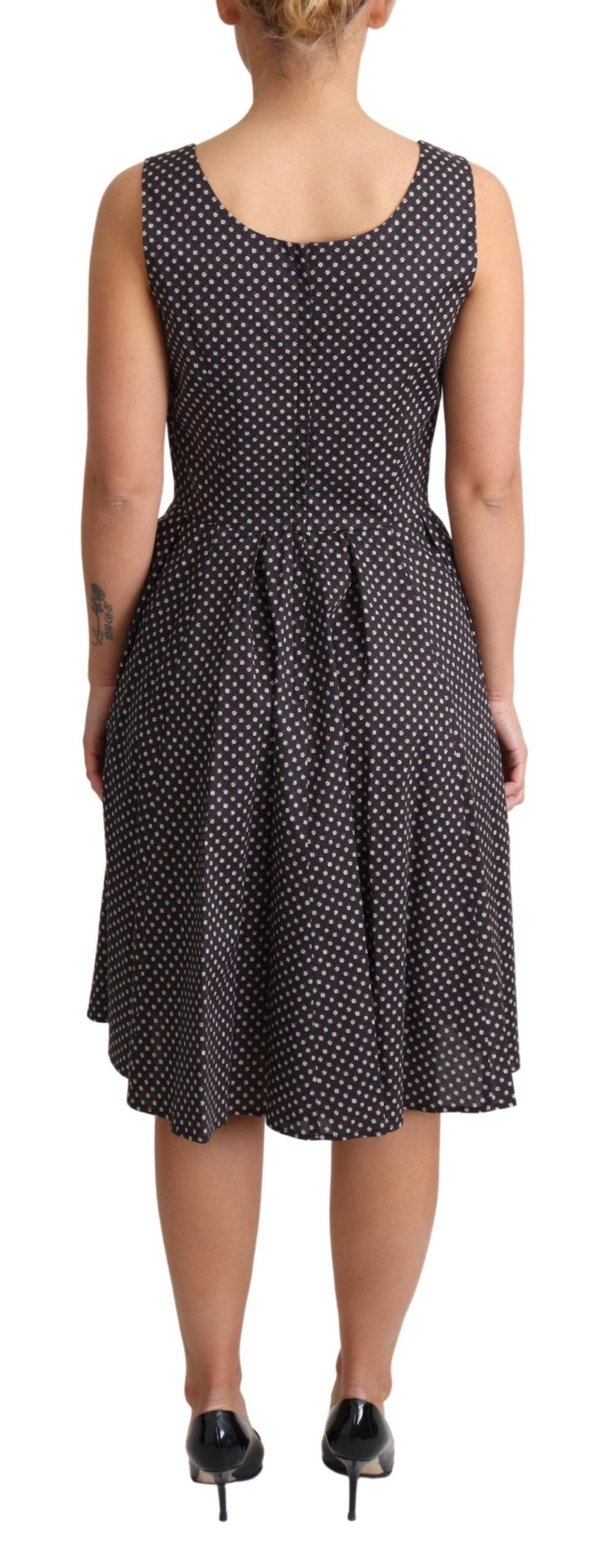 Dolce & Gabbana black floral cotton A-line stretch dress displayed on a hanger with vibrant floral pattern.