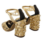 Dolce & Gabbana black leather ankle strap shoes with gold accents and studded detailing, stylish and luxurious footwear.