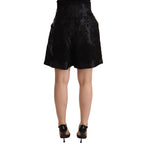 Dolce & Gabbana black floral brocade high-waist mini shorts with intricate pattern and tailored fit.