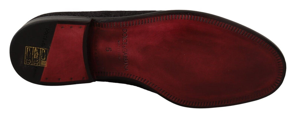 Black floral brocade slippers by Dolce & Gabbana featuring a loafer style and luxurious fabric detailing.