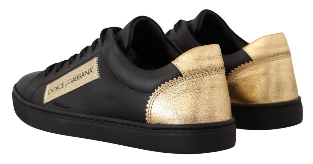 Dolce & Gabbana black and gold leather low top sneakers for women, stylish footwear with a sleek design.