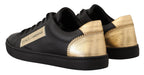 Dolce & Gabbana black and gold leather low top sneakers for women, stylish footwear with a sleek design.